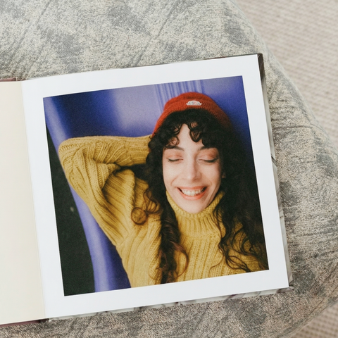 Cameo cover layflat photo book open to a black-and-white wedding portrait spread