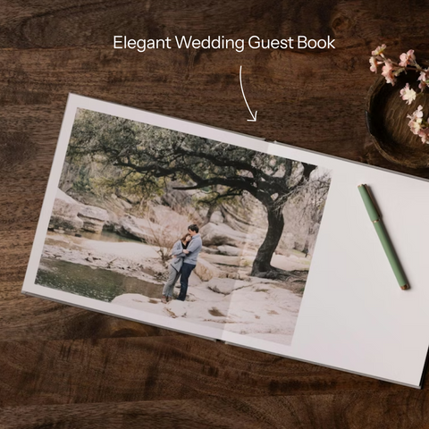 Combo cover layflat photo book displayed open on a neutral linen surface