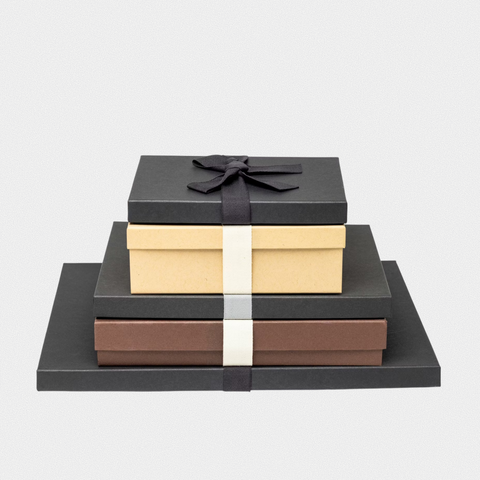 Stack of layflat photo books with photo covers in a home interior setting